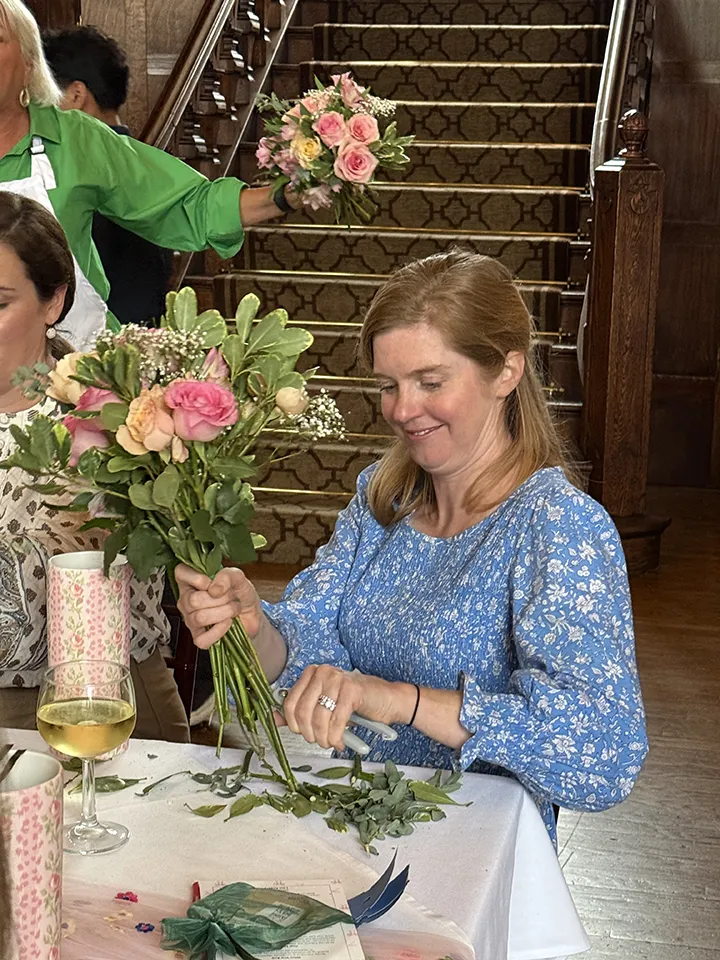 Kelly Fasciano creating a floral bouquet at Smile Farms Sips & Stems.